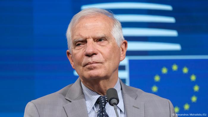 Josep Borrell in front of the EU eymbol