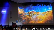 Michael Ressler, Project Scientist for the JWST Mid-Infrared Instrument, speaks in front of an image of the Carina Nebula, captured on the James Webb Space Telescope, during a news conference at the NASA Jet Propulsion Laboratory Tuesday, July 12, 2022, in Pasadena, Calif. (AP Photo/Marcio Jose Sanchez)