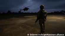 A helicopter carrying gang leaders who are operating inside the Bellavista jail as they are transferred to other jails after a deadly riot broke out overnight in Santo Domingo de los Tsachilas, Ecuador, Monday, May 9, 2022. (AP Photo/Dolores Ochoa)