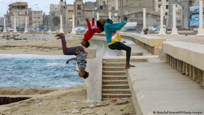  Young people practice parkour stunts along a beach in the second city of Benghazi in eastern Libya.