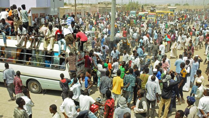 Scores of Hausa people gather outside local government offices in Port Sudan, on the Red Sea