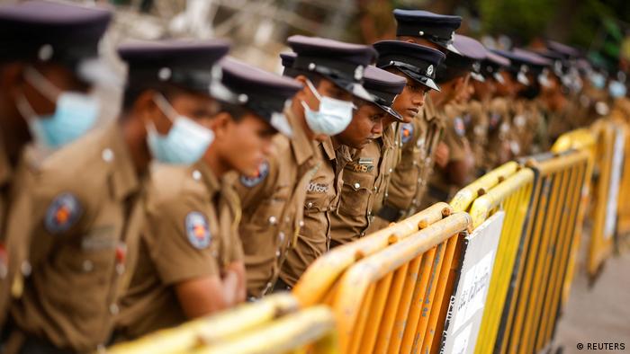 Sri Lankan police behind a yellow barrier