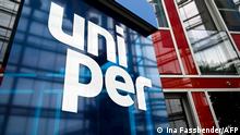 The logo of energy supplier Uniper is seen before a press conference about the government's rescue plan at their headquarters in Duesseldorf, western Germany on July 8, 2022. - The German cabinet on July 5, 2022 had approved plans to quickly prop up struggling energy companies, such as Uniper, as the soaring price of gas puts the sector under pressure. (Photo by Ina FASSBENDER / AFP)