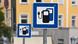 Close-up of a pair of signs in Munich in Germany showing the availability of a charging point for electric vehicles. Close-up of a pair of signs in Munich in Germany showing the availability of a charging point for electric vehicles.
