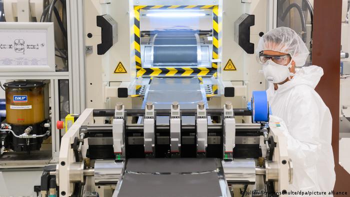 Ein Mitarbeiter steht in Schutzkleidung in einer Pilotanlage zur Batteriezellenproduktion im VW-Werk Salzgitter an einer Anlage zum Kalandrieren (Verdichten) von Anoden oder Kathoden