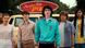 A film still from 'Stranger Things': A group of young people in 1980s style stand in front of a van with an ad that reads 'Surfer Boy Pizza'. A film still from 'Stranger Things': A group of young people in 1980s style stand in front of a van with an ad that reads 'Surfer Boy Pizza'.