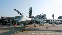 A Chinese-made CH-5 (Caihong-5 or Rainbow 5) reconnaissance and combat drone and its compatible missiles are on display during the 11th China International Aviation and Aerospace Exhibition, also known as Airshow China 2016, in Zhuhai city, south China's Guangdong province, 2 November 2016.