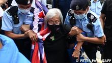 (FILES) This photo taken on on July 1, 2021 shows activist Alexandra Wong (C), also known as Grandma Wong, being taken away by police while protesting on the 24th anniversary of Hong Kong's handover from Britain, in Hong Kong. - Wong, who became a fixture of Hong Kong's democracy protests was jailed on July 13, 2022 for eight months for unlawful assembly, a day after courts imprisoned a terminally ill 75-year-old activist. (Photo by Peter PARKS / AFP)