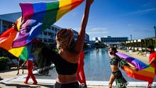 Dancers of the cheerleading team perform with rainbow flags at the Gran Muthu Rainbow Hotel, in Guillermo Key in Ciego de Avila Province, Cuba, on November 27, 2021. - Cuba's first LGBT hotel, which had been inaugurated in December 2019, but very soon had to close due to the coronavirus pandemic, reopened to attract that tourist segment at a time when authorities are studying the approval of equal marriage on the island. Under all preventive sanitary measures, this five-star accommodation received its first clients again on November 15, when Cuba reopened its borders after 10 months of confinement. (Photo by YAMIL LAGE / AFP) (Photo by YAMIL LAGE/AFP via Getty Images)