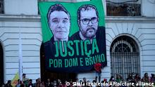 Supporters of Brazil's former president who is running for reelection, Luiz Inacio Lula da Silva, open a large banner with images of slain British journalist Dom Phillips, left, and slain Indigenous expert Bruno Pereira with a Portuguese phrase that reads Justice for Dom and Bruno, during a campaign rally at Cinelandia square, in Rio de Janeiro, Brazil, Thursday, July 7, 2022. (AP Photo/Silvia Izquierdo)