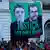 Um grande cartaz com os rostos de Dom Phillips e Bruno Pereira está pendurado em frente a um prédio no Rio de Janeiro durante um protesto pela morte do indigenista brasileiro e do jornalista britânico na região amazônica.