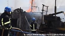Firefighters work at a site of a Russian missile strike in a sea port of Odesa, as Russia's attack on Ukraine continues, Ukraine July 23, 2022. Press service of the Joint Forces of the South Defence/Handout via REUTERS ATTENTION EDITORS - THIS IMAGE HAS BEEN SUPPLIED BY A THIRD PARTY.