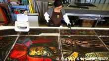 French glassmaker Flavie Vincent-Petit, works on cleaning and restoring stained glass windows of Notre-Dame de Paris Cathedral, at her workshop in the town of Troyes, northeastern France, on July 21, 2022. - Among the 8 French workshops selected to participte in the restoration of the Notre-Dame de Paris Cathedral, the Vincent-Petit factory in Troyes (Aube) is responsible for bringing to light several of the 39 large high bays, surfaces of about three meters wide by 8 to 9 meters high, explains to AFP the one who directs it, the master glassmaker Flavie Vincent-Petit. (Photo by FRANCOIS NASCIMBENI / AFP)