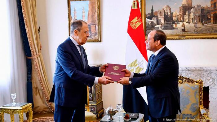 Russia's foreign minister Sergey Lavrov and Egypt's President Abdel Fattah el-Sissi hold a document together