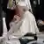 Pope Francis sits in a wheelchair during his visit to Canada