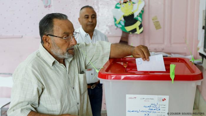 People cast their ballots at a polling station during a referendum on a new constitution in Tunis, Tunisia