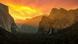 Yosemite National Park valley at sunrise. The skies are pink and orange. A waterfall can be seen running down a mountain. Yosemite National Park valley at sunrise. The skies are pink and orange. A waterfall can be seen running down a mountain.