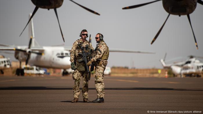 Two German soldiers stood near planes at the Gao airport in Mali. Undated archive image.
