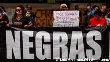 SAO GONCALO, BRAZIL - NOVEMBER 22: Demonstrators hold banners and signs in front of the entrance to the Carrefour Niteroi-Manilha branch as protests erupt against racism on November 22, 2020 in Sao Goncalo, Brazil. In recent days there have been protests across the country in the wake of the death of a black man Joao Alberto Silveira Freitas, who was beaten at one of the branches of a Carrefour supermarket by two security guards in the city of Porto Alegre. This happened the day before that Brazil celebrates the Black Consciousness Day. (Photo by Luis Alvarenga/Getty Images)