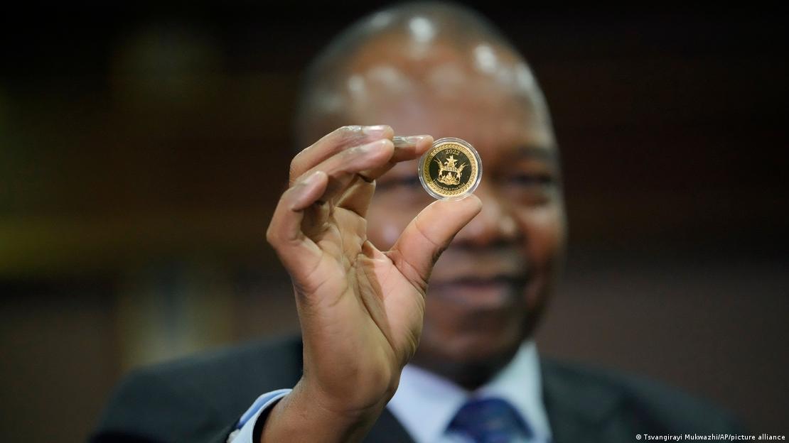 Reserve Bank of Zimbabwe Governor, John Mangudya holds a sample of a gold coin