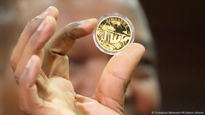 Reserve Bank of Zimbabwe Governor, John Mangudya holds a sample of a gold coin at the launch in Harare