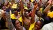 Supporters of Kenya's Deputy President William Ruto cheer and raise their hands in the air, many of them are wearing yellow Supporters of Kenya's Deputy President William Ruto cheer and raise their hands in the air, many of them are wearing yellow