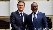 Beninese President Patrice Talon (R) poses with France's President Emmanuel Macron (L) upon his arrival at the Marina palace in Cotonou on July 27, 2022, during Macron's official visit in Benin. (Photo by Ludovic MARIN / AFP)