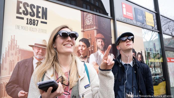 A woman and a man wear virtual reality glass in Essen, Germany.