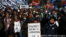 Members of social organizations march to Plaza de Mayo square demanding a universal basic salary and social aid amid the growing inflation in Buenos Aires, on July 28, 2022. (Photo by Luis ROBAYO / AFP) (Photo by LUIS ROBAYO/AFP via Getty Images)