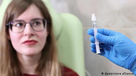 Woman looking at a vaccine