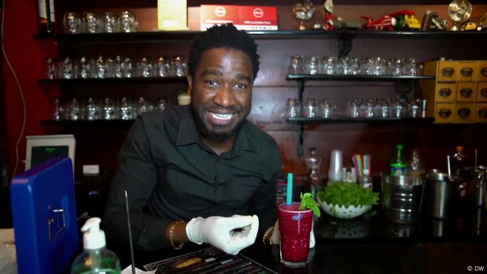 A bartender serving a Ghanaian specialty, Akpeteshie