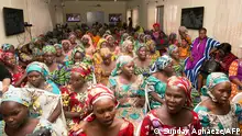 This handout photo released on May 30, 2017 by PGDBA & HND Mass Communication shows newly-rescued Chibok school girls waiting upon their arrival for rehabilitation at the Women Development Centre in Abuja. - The Nigerian minister for women affairs has said that the newly rescued 82 Chibok school girls will not be going back to their rural hometown to complete their schooling. Speaking at a ceremony welcoming 82 newly rescued girls to a government rehabilitation facility in the country's capital of Abuja, Aisha Alhassan said all the girls will be heading back to class in September, without specifying where. (Photo by SUNDAY AGHAEZE / PGDBA & HND Mass Communication / AFP) / RESTRICTED TO EDITORIAL USE - MANDATORY CREDIT AFP PHOTO / HO/ PGDBA&HD MASS CONMMUNICATION/ SUNDAY AGHAEZE - NO MARKETING NO ADVERTISING CAMPAIGNS - DISTRIBUTED AS A SERVICE TO CLIENTS