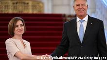 Moldovan President Maia Sandu (L) and Romanian President Klaus Iohannis shake hands prior talks at the Cotroceni Palace, the Romanian Presidency headquarters, in Bucharest on July 29, 2022. (Photo by Daniel MIHAILESCU / AFP) (Photo by DANIEL MIHAILESCU/AFP via Getty Images)
