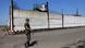 A soldier stands guard next to a wall of a prison in Olenivka, controlled by Russian-backed separatist forces, eastern Ukraine, Friday, July 29, 2022 A soldier stands guard next to a wall of a prison in Olenivka, controlled by Russian-backed separatist forces, eastern Ukraine, Friday, July 29, 2022