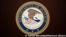 The U.S. Department of Justice logo is seen on a podium following a news conference in the office of the U.S. Attorney for the District of Maryland in Baltimore, Wednesday, March 1, 2017. (AP Photo/Patrick Semansky)