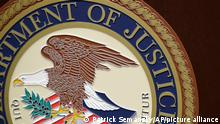 The U.S. Department of Justice logo is seen on a podium following a news conference in the office of the U.S. Attorney for the District of Maryland in Baltimore, Wednesday, March 1, 2017. (AP Photo/Patrick Semansky)
