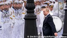 Russian President Vladimir Putin arrives to attend the military parade during Navy Day celebrations, in the Neva River, St.Petersburg, Russia, Sunday, July 31, 2022. (AP Photo/Dmitri Lovetsky)