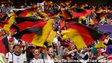 Germany supporters on the stands wave flags before the Women's Euro 2022 final soccer match between England and Germany at Wembley stadium in London, Sunday, July 31, 2022. (AP Photo/Alessandra Tarantino)