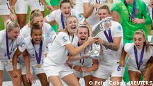 Soccer Football - Women's Euro 2022 - Final - England v Germany - Wembley Stadium, London, Britain - July 31, 2022
England's Leah Williamson and Millie Bright lift the trophy as they celebrate with teammates after winning Women's Euro 2022 REUTERS/Peter Cziborra