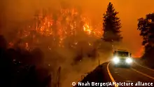 A firetruck drives along California Highway 96 as the McKinney Fire burns in Klamath National Forest, Calif., Saturday, July 30, 2022. (AP Photo/Noah Berger)