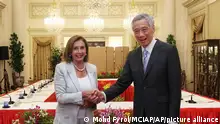 In this photo provided by Ministry of Communications and Information, Singapore, U.S. House Speaker Nancy Pelosi, left, and Prime Minister Lee Hsien Loong shake hands at the Istana Presidential Palace in Singapore, Monday, Aug. 1, 2022. Pelosi arrived in Singapore early Monday, kicking off her Asian tour as questions swirled over a possible stop in Taiwan that has fueled tension with Beijing. (Ministry of Communications and Information, Singapore via AP)