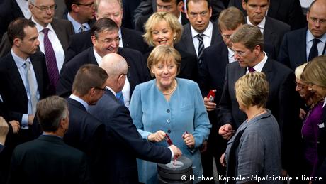 Angela Merkel and other parliamentarians in the Bundestag in 2011 voting to end nuclear power