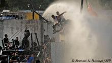 Security forces use a water cannon to prevent supporters of the Coordination Framework from entering the capital Baghdad's high-security Green Zone on August 1, 2022, during a counter-protest against Sadr's loyalists who have been occupying parliament. - Iraqi security forces were on high alert in Baghdad as tensions soared after rivals of Shiite Muslim cleric Moqtada Sadr, whose supporters are occupying the parliament, called for counter-demonstrations. (Photo by Ahmad Al-rubaye / AFP) (Photo by AHMAD AL-RUBAYE/AFP via Getty Images)