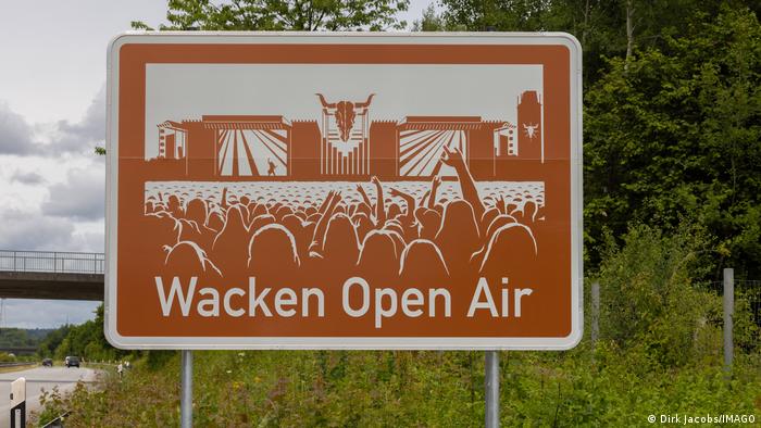 Brown color sign on a highway indicating Wacken Open Air