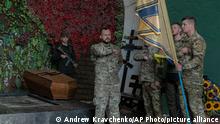 Officers of the Azov regiment pay their last tribute to a serviceman killed in a battle against the Russian troops in a city crematorium in Kyiv, Ukraine, Thursday, July 21, 2022. (AP Photo/Andrew Kravchenko)