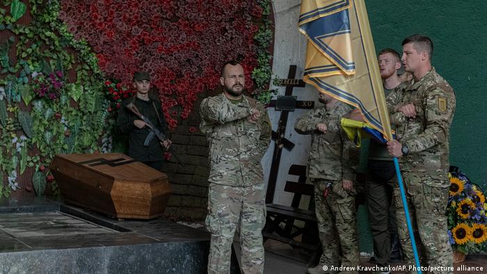 Officers of the Azov Regiment pay their last tribute to a serviceman killed in a battle against the Russian troops in a city crematorium in Kyiv