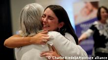 People hug during a Value Them Both watch party after a question involving a constitutional amendment removing abortion protections from the Kansas constitution failed Tuesday, Aug. 2, 2022, in Overland Park, Kan. (AP Photo/Charlie Riedel)