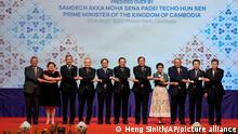 From left to right; Malaysian Foreign Minister Saifuddin Abdullah, Philippines Foreign Affairs acting Undersecretary Theresa Lazaro, Singapore Foreign Minister Vivian Balakrishnan, Thailand's Foreign Minister Don Pramudwinai, Vietnam Foreign Minister But Thanh Son, Cambodia's Prime Minister Hun Sen, Cambodia's Foreign Minister Peak Sokhonn, Indonesia's Foreign Minister Retno Marsudi, Brunei Second Minister of Foreign Affairs Erywan Yusof, Laos Foreign Minister Saleumxay Kommasith, and Secretary-General of ASEAN Lim Jock Hoi poses for a group photographer during the opening for the 55th ASEAN Foreign Ministers' Meeting (55th AMM) at a hotel in Phnom Penh, Cambodia, Wednesday, Aug. 3, 2022. (AP Photo/Heng Sinith)