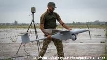 A Ukrainian soldier launches FlyEye WB Electronics SA, a Polish reconnaissance drone, which is in service with the Ukrainian army, in Kyiv region, Ukraine, Tuesday, Aug. 2, 2022. (AP Photo/Efrem Lukatsky)