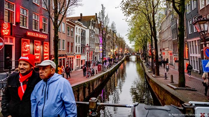 People strolling through the Netherlands Red Light District in Amsterdam